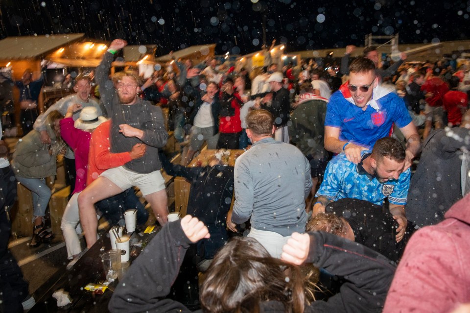 England fans throw their drinks in the air after a goal during the Euro 2020 semi final match between England and Denmark on the 7th of July 2021 at the outdoor screen at Folkestone Harbour Arm, in Folkestone, United Kingdom. (photo by Andrew Aitchison / In pictures via Getty Images)