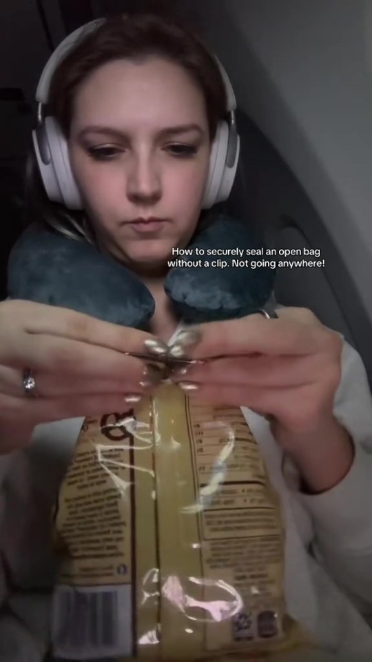 Woman sealing an open bag of snacks without a clip.