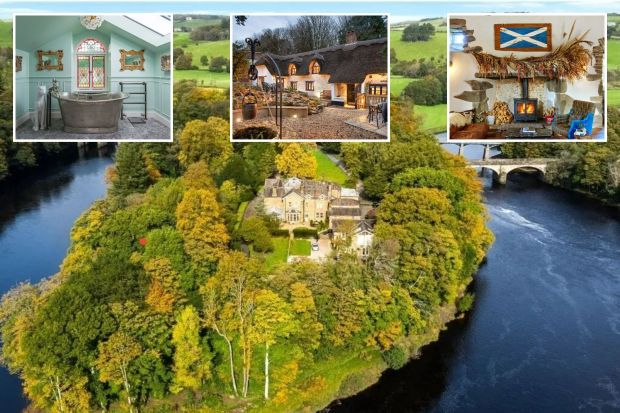An image collage containing 4 images, Image 1 shows Aerial view of a house on a river island surrounded by autumn trees and two bridges, Image 2 shows Elegant bathroom with a clawfoot tub, stained-glass window, and decorative mirrors, Image 3 shows Thatched-roof cottage at dusk with well and patio seating, Image 4 shows Stone fireplace with a wood-burning stove, decorated with dried flowers and a Scottish flag