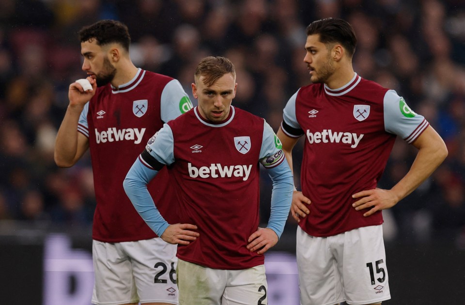 Three West Ham United soccer players looking dejected.