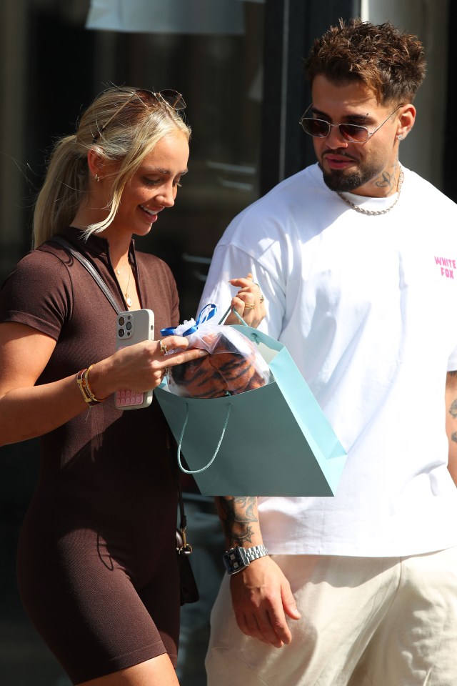 Nathan Campbell and Abi Moores leaving a baby boutique in London.