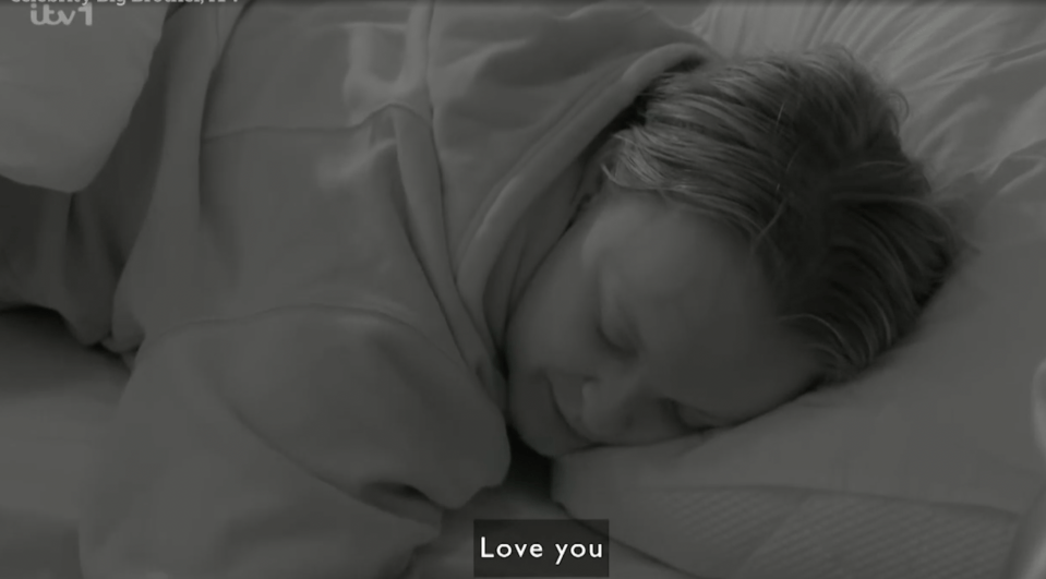 Screenshot of a person sleeping in bed with the words "Love you" displayed.