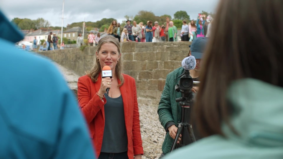 Reporter holding microphone during interview.