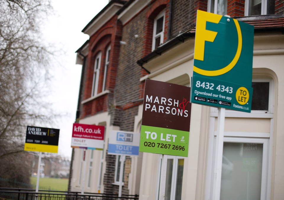 Estate agent signs outside houses in north London.