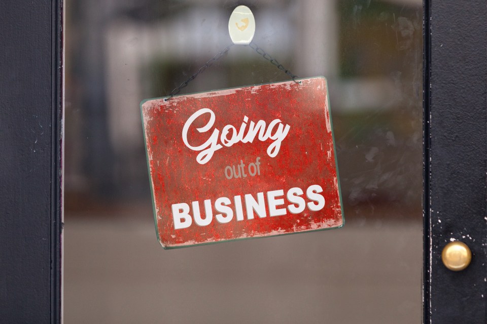 Red "Going out of business" sign in a store window.