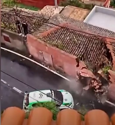 Rally car crashing into a house.