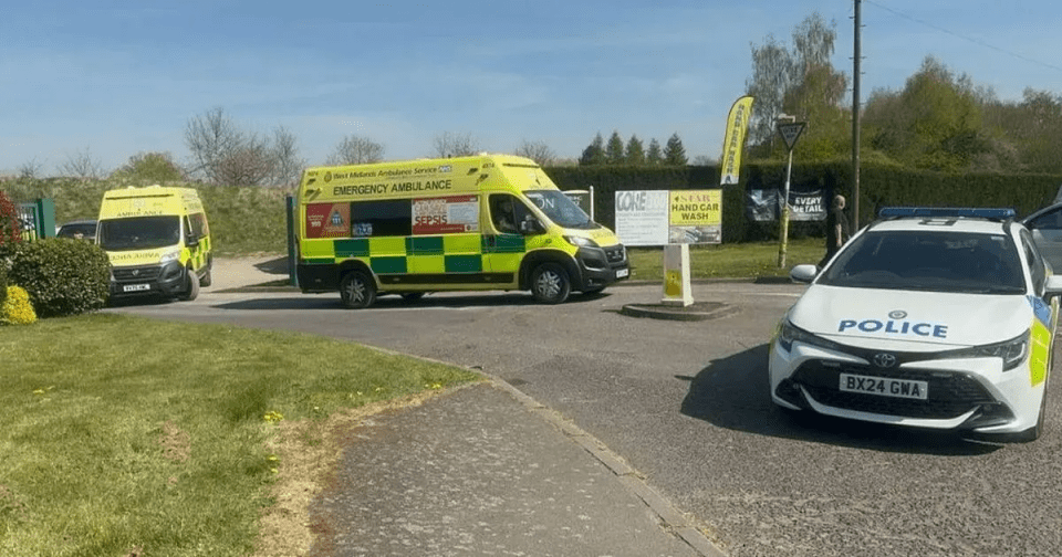 Police car and two ambulances at a car wash.