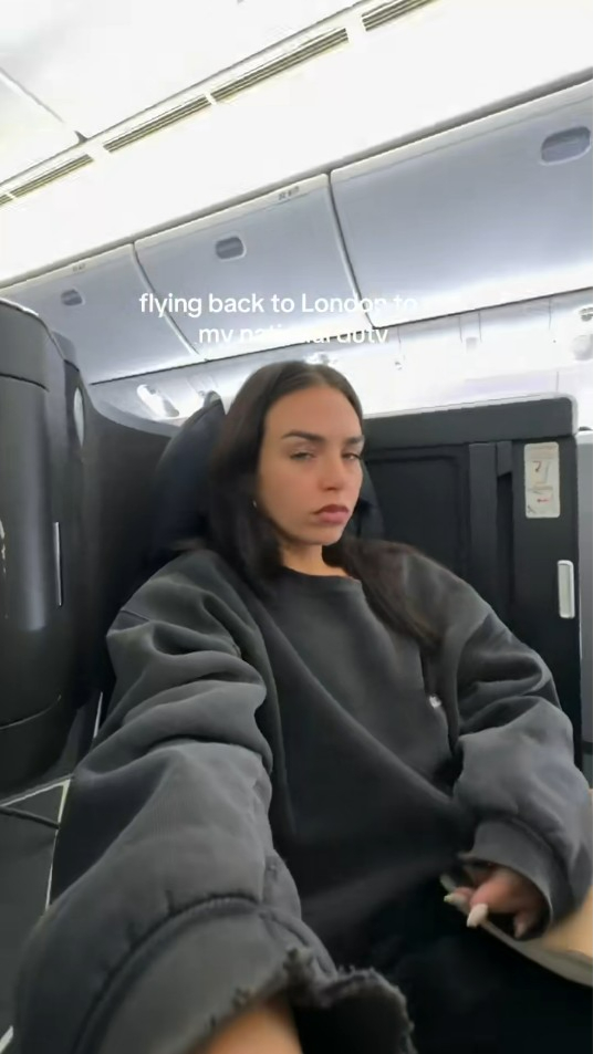 Woman on airplane flying back to London.