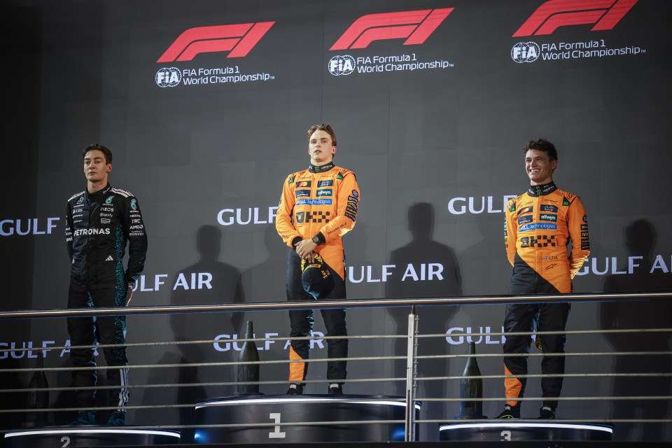 George Russell (Mercedes), Oscar Piastri (McLaren), and Lando Norris (McLaren) on the F1 podium.