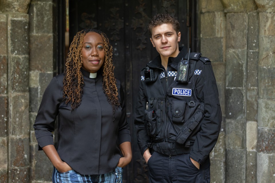 A vicar and a police officer standing together.