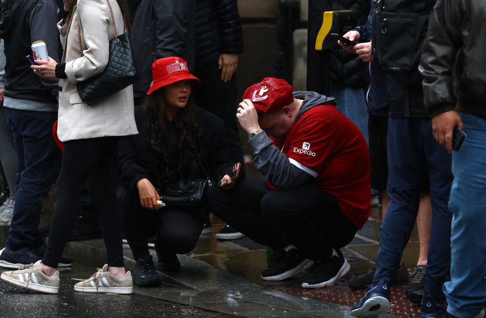 Liverpool fans reacting to an incident at a victory parade.