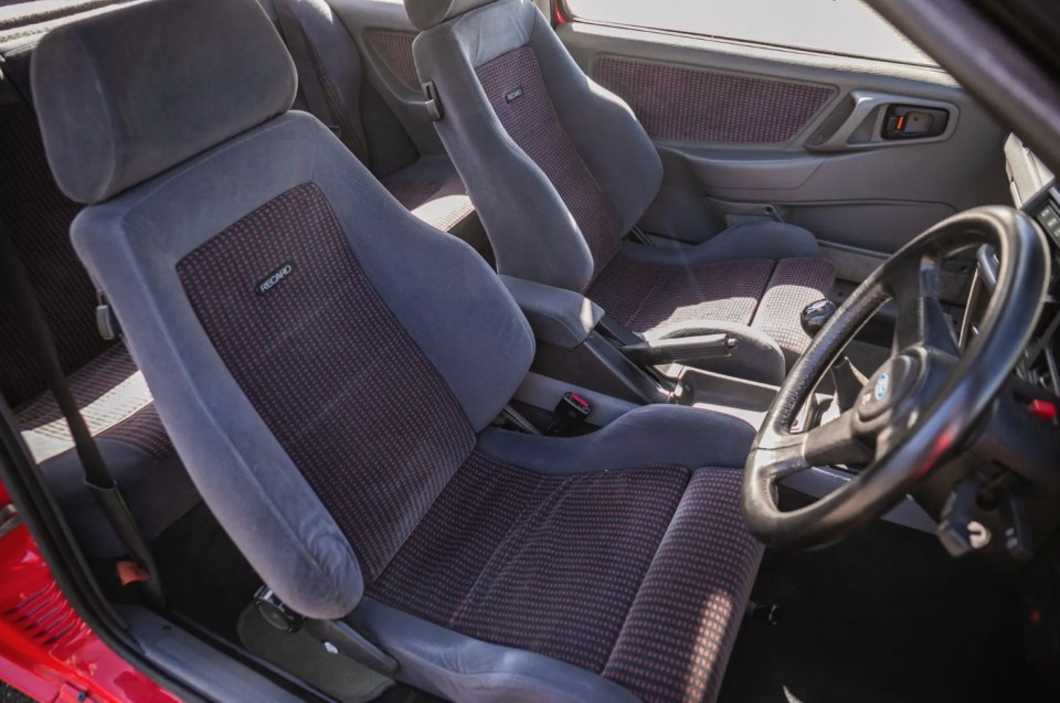 Interior of a red 1986 Ford Sierra RS Cosworth with Recaro seats.