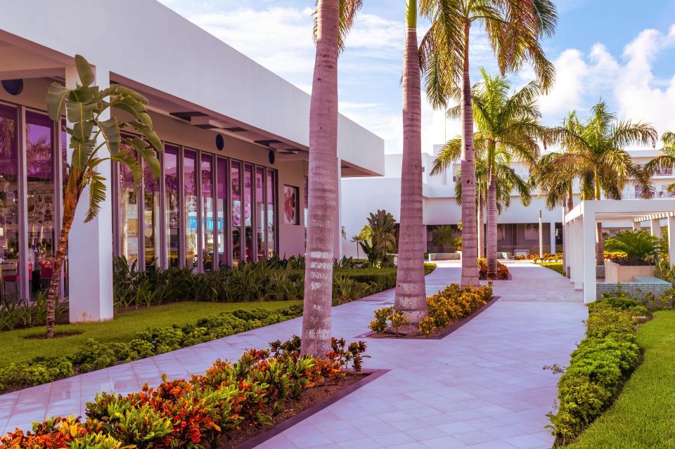 Landscaped walkway outside a hotel.