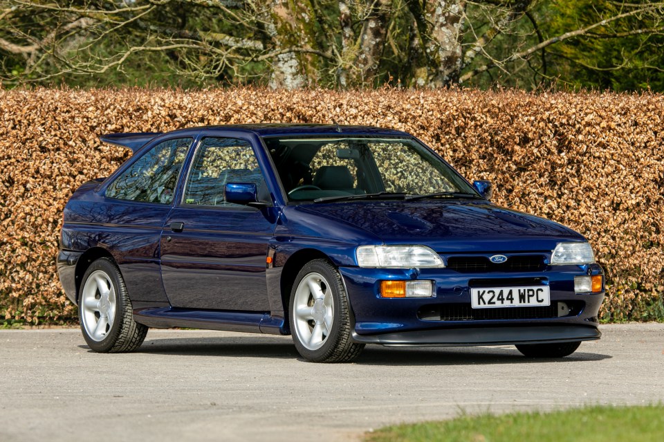 A navy blue 1993 Ford Escort RS Cosworth Lux Big Turbo.