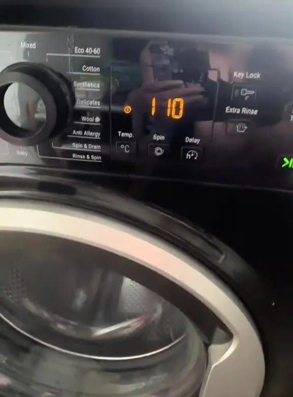 Washing machine control panel showing a hidden cleaning code.