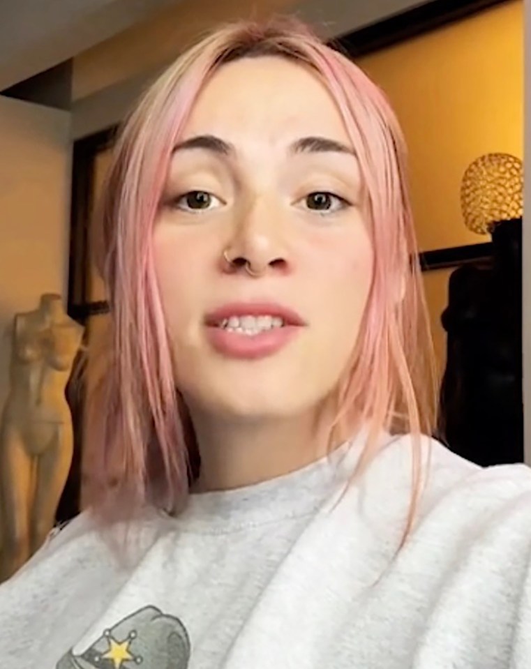 Woman with pink hair answering the question, "How much does it cost?"