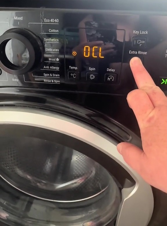 Washing machine control panel showing an "OCL" code.