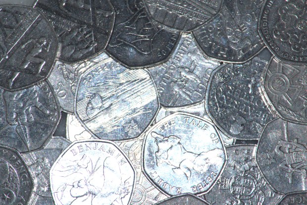 Pile of UK fifty pence coins.