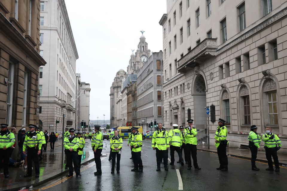 Police officers on Water Street during a Liverpool parade.