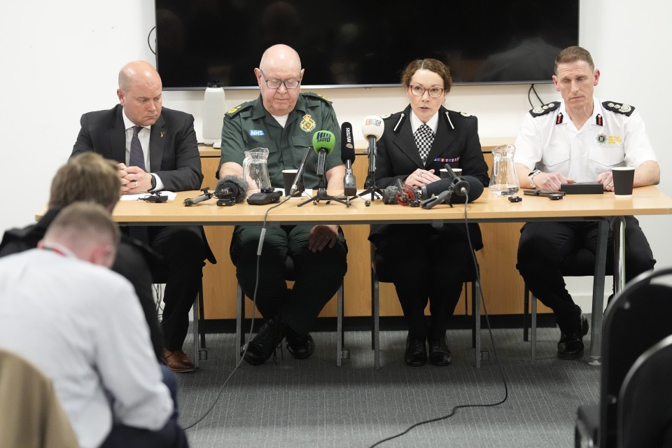 Four officials at a press conference.