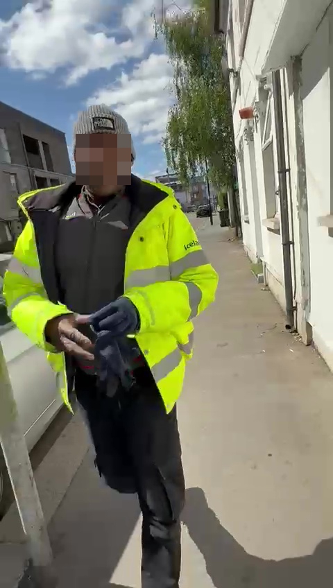 Iceland delivery driver walking down a sidewalk.