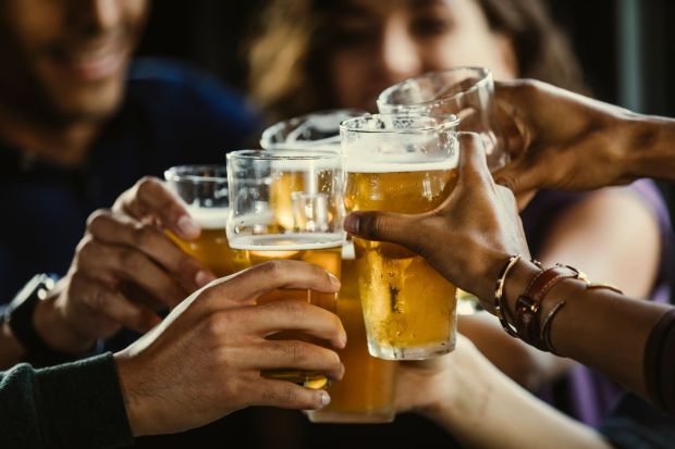 An image collage containing 1 images, Image 1 shows A group of friends toasting with beer