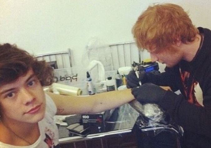 Harry Styles getting a tattoo from Ed Sheeran.
