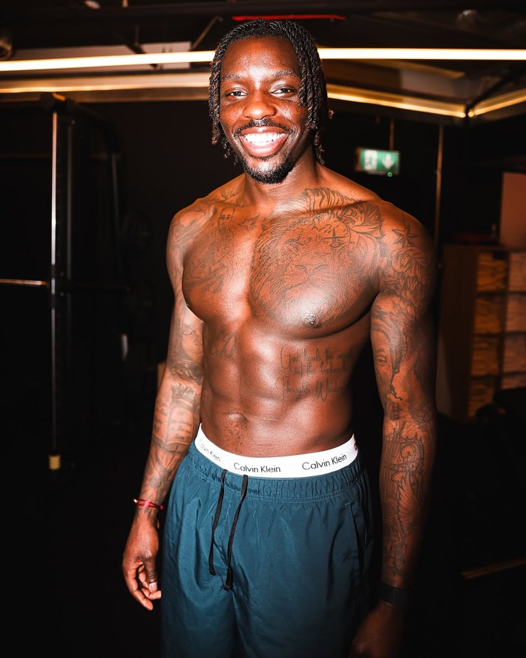 Portrait of a smiling man with tattoos.